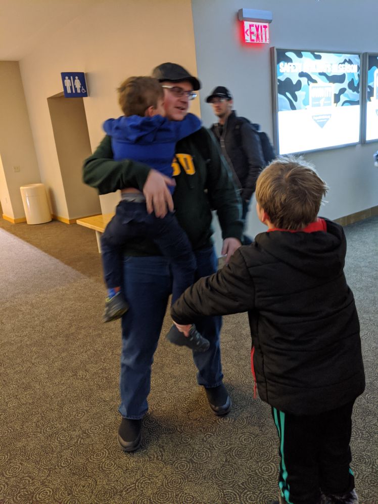Getting hugged at the Bismarck airport. Feels good man!