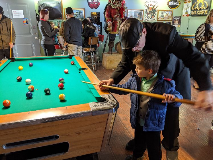 Showing Owen the finer points of shooting pool.