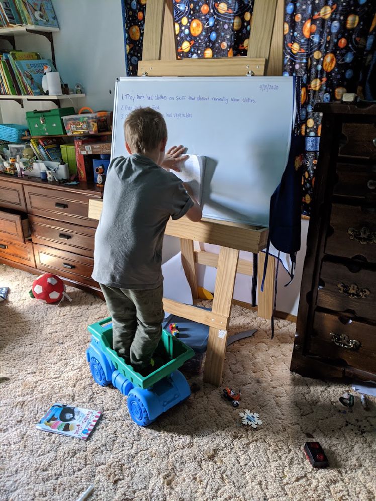Owen working on his handwriting in a dump truck.